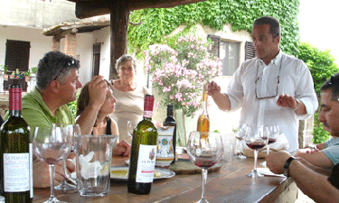 Tuscany driver guide Giorgio Fronimos explaining Chianti wines to guests